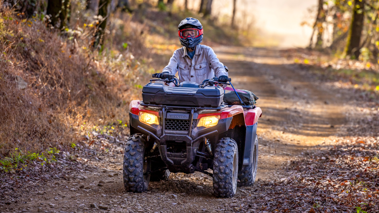 Driver front facing in woodland on dirt road. Avenger Red.