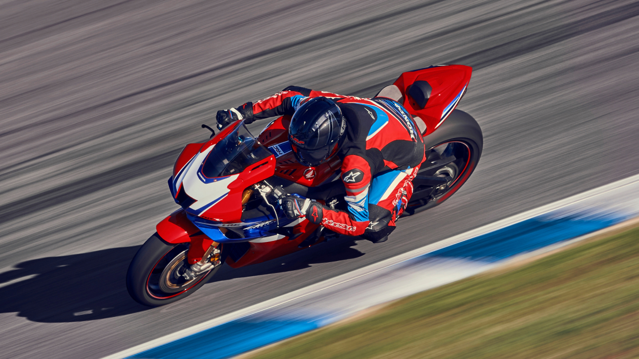 High angle of Driver on Grand Prix Red Fireblade turning left at high speed.