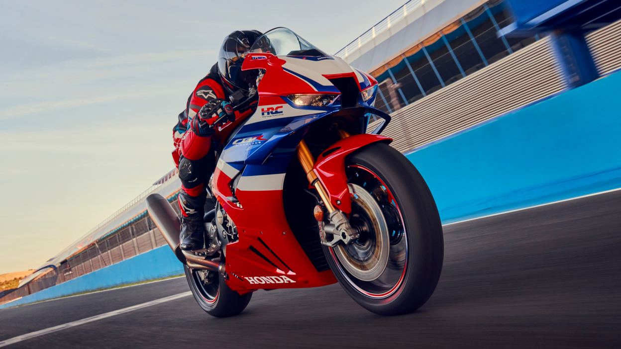 Right angle of Driver on Grand Prix Red Fireblade on track at high speed.