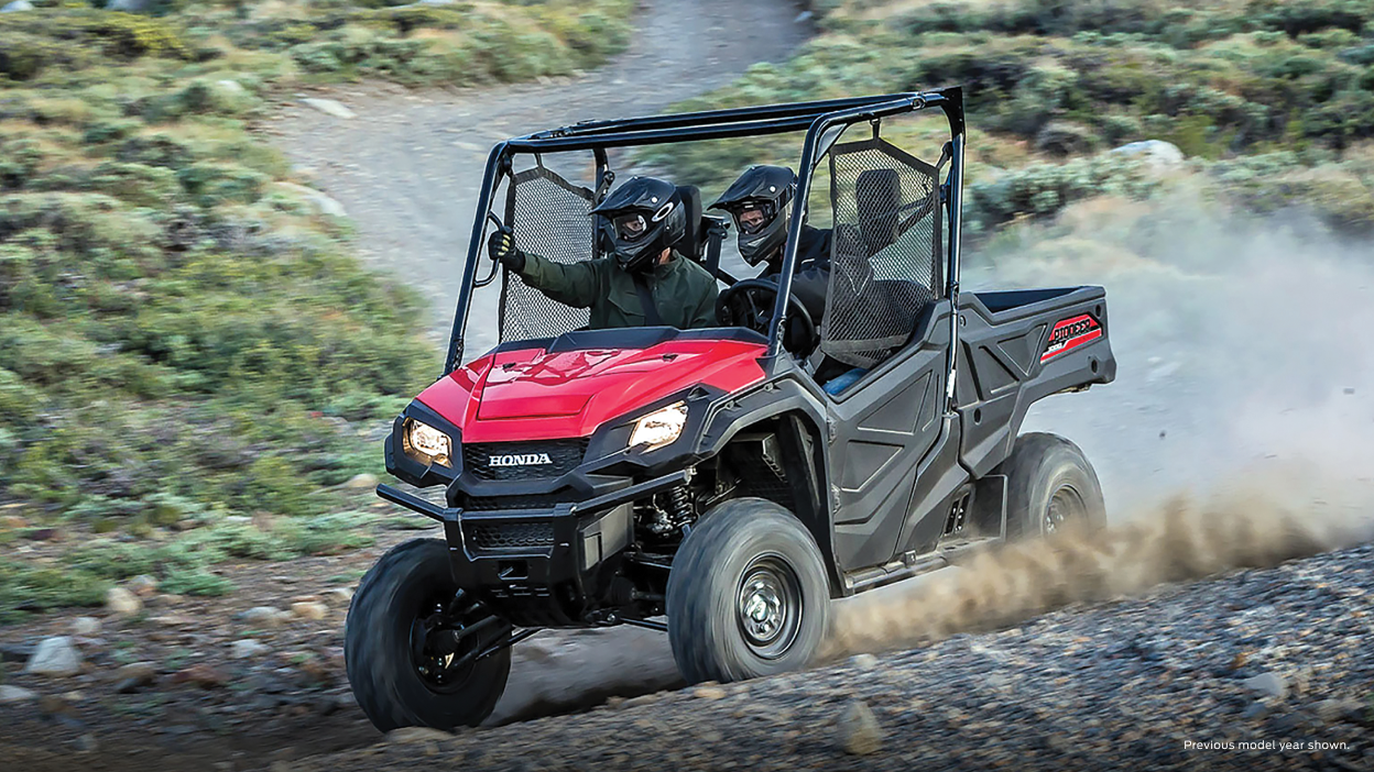 Two riders in a Honda Pioneer